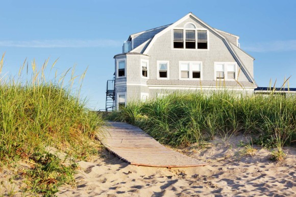 New England beach house by the boardwalk in early morning sun