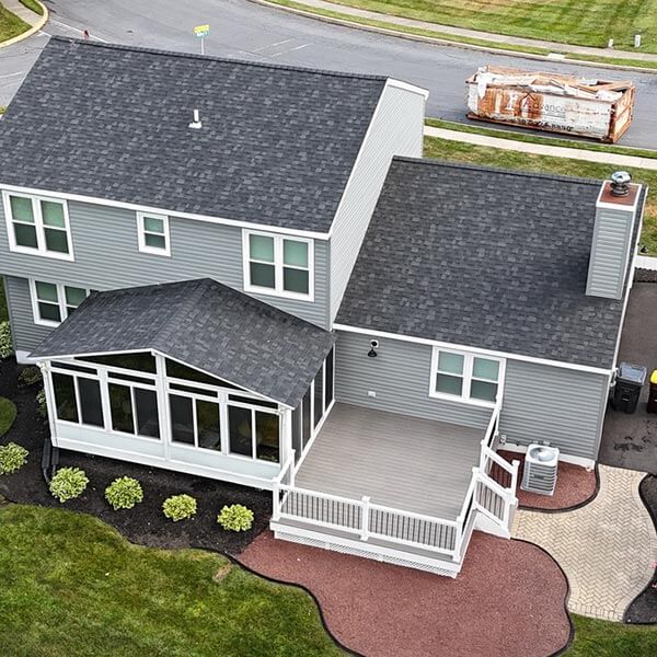 aerial view of home exterior with screened porch and deck