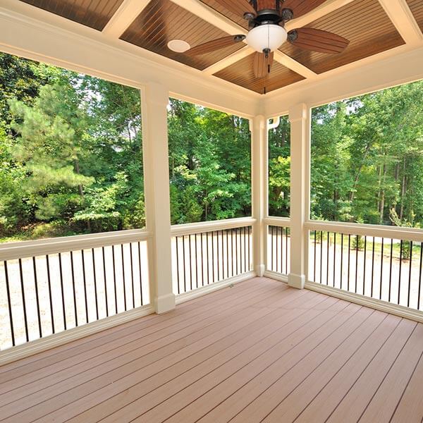 view of woods from home deck with railing
