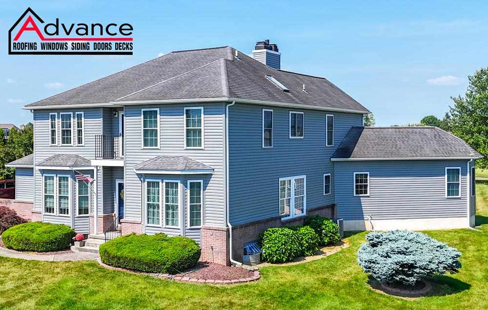 Two-story home with new asphalt shingle roofing service in Newark, DE.